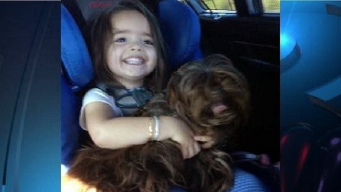 Jessica's daughter Jemma holding her Shih Tzu, Tula.
